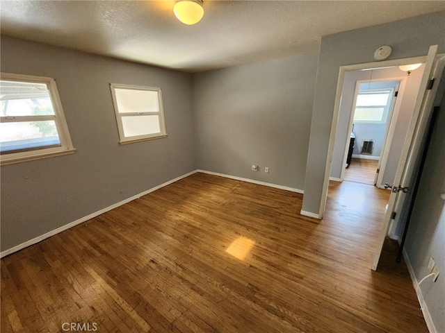 unfurnished room featuring hardwood / wood-style floors