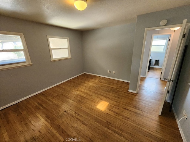 empty room with wood-type flooring