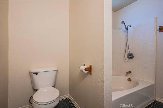 bathroom with toilet, tile patterned floors, and tub / shower combination