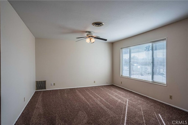 spare room with ceiling fan and carpet