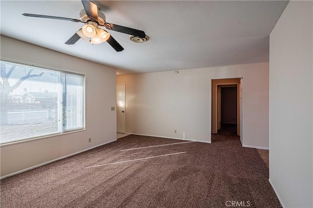 carpeted empty room featuring ceiling fan