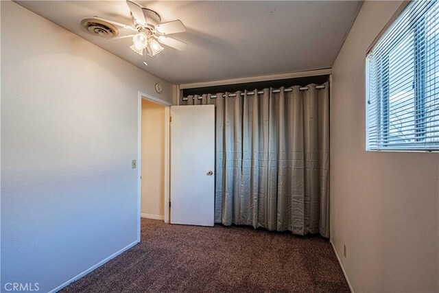 unfurnished bedroom featuring ceiling fan and carpet floors