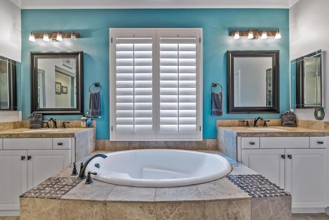 bathroom featuring a relaxing tiled tub and vanity