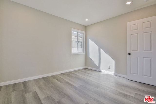 empty room with light hardwood / wood-style flooring