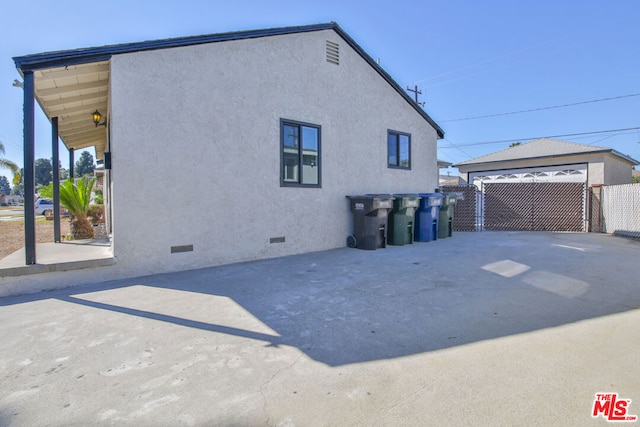 back of property with a garage and an outdoor structure