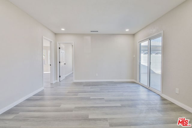 empty room with light hardwood / wood-style flooring