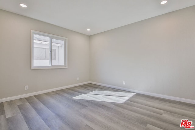 spare room featuring light hardwood / wood-style flooring