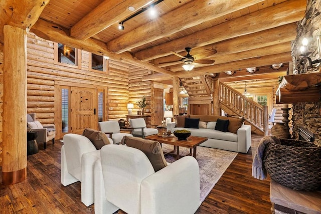 living room featuring wood ceiling, ceiling fan, dark wood-type flooring, rustic walls, and beam ceiling