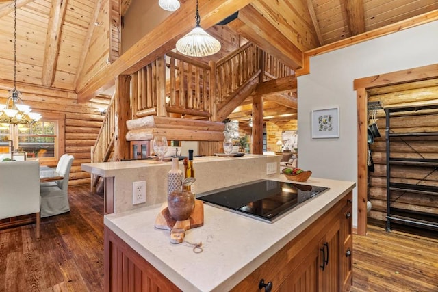 kitchen featuring pendant lighting, a center island, and log walls