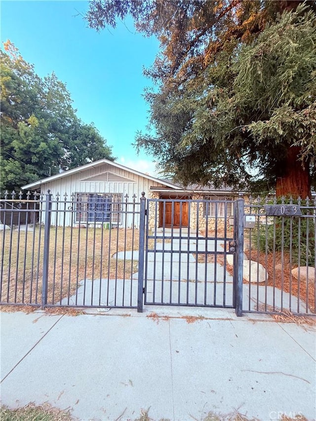 view of gate with a yard