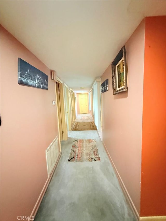 hall featuring carpet flooring