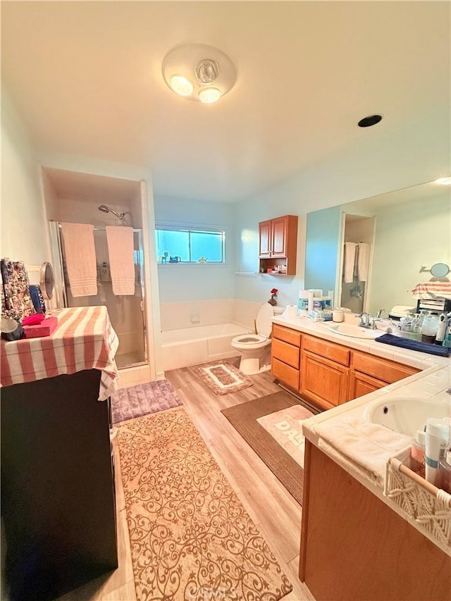 bathroom featuring vanity, a tub, and wood-type flooring