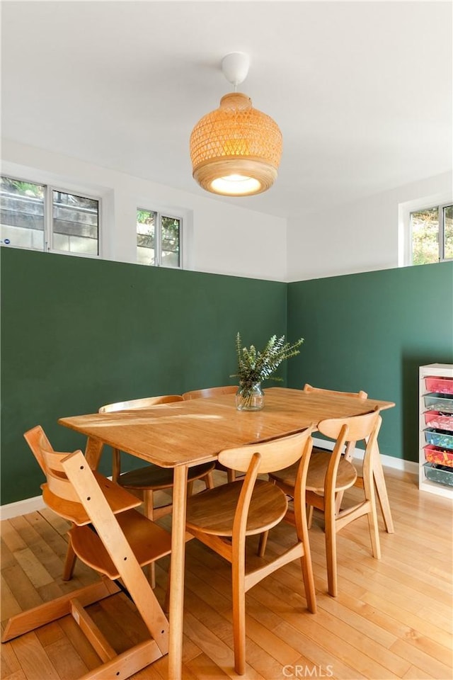 dining space with a healthy amount of sunlight and hardwood / wood-style flooring