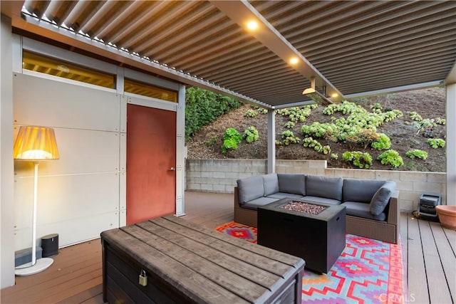 wooden terrace featuring an outdoor living space with a fire pit