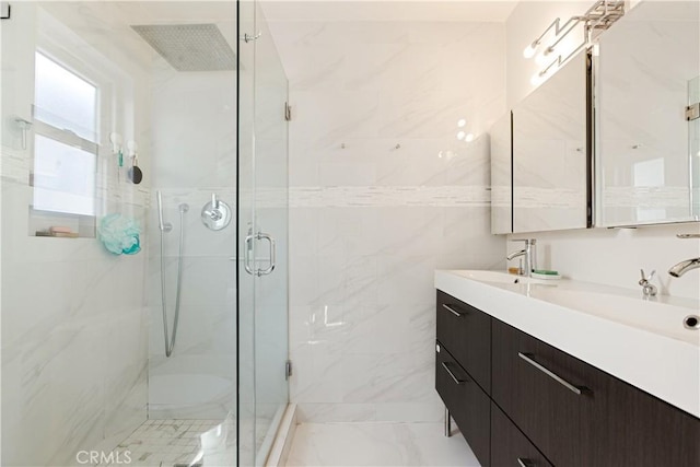 bathroom featuring walk in shower and vanity