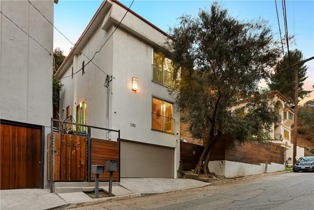 property exterior at dusk featuring a garage