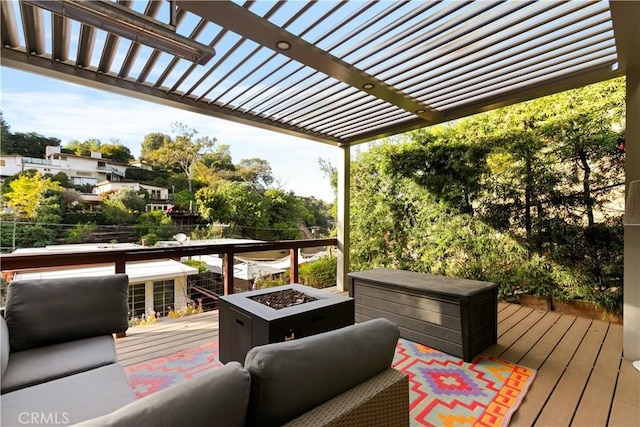 wooden deck with a pergola and an outdoor fire pit