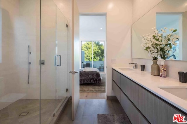 bathroom with an enclosed shower and vanity