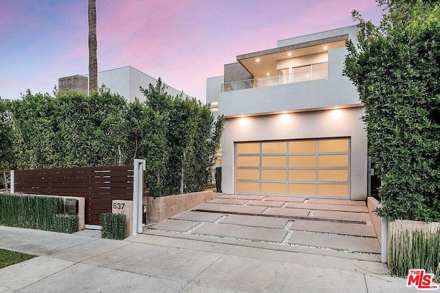 modern home with a garage and a balcony