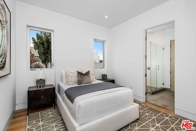 bedroom with hardwood / wood-style flooring