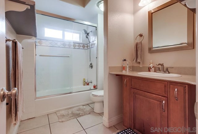 full bathroom with vanity, tile patterned floors, enclosed tub / shower combo, and toilet