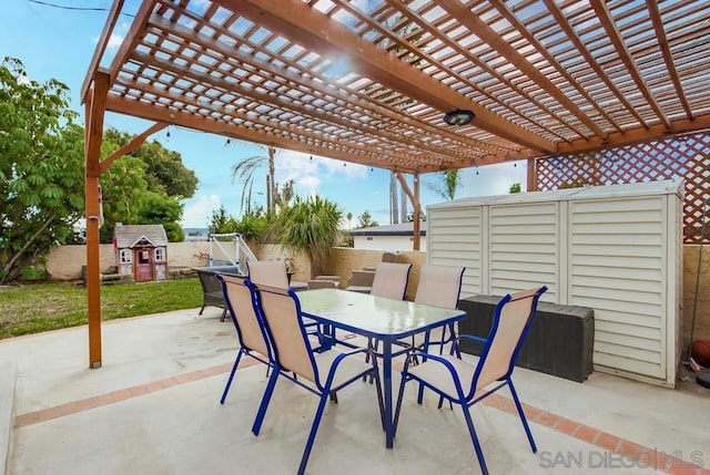 view of patio / terrace with a storage unit and a pergola