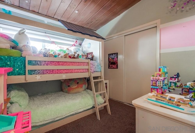 bedroom featuring carpet floors, vaulted ceiling, wooden ceiling, and a closet