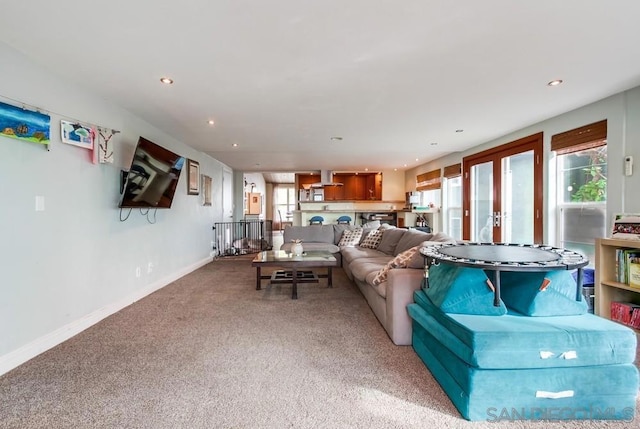 carpeted living room featuring french doors