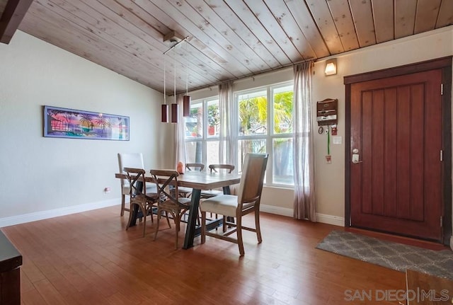 dining room with vaulted ceiling, hardwood / wood-style floors, and wood ceiling