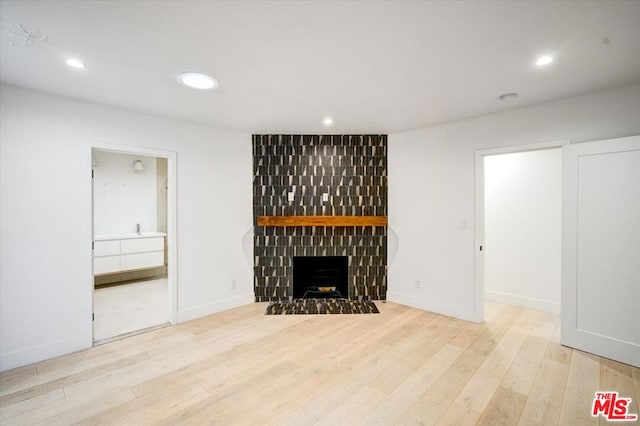 unfurnished living room featuring light hardwood / wood-style flooring and a fireplace