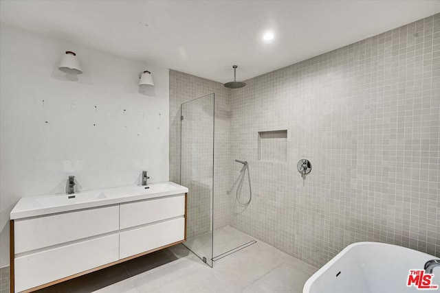 bathroom featuring tile patterned floors, separate shower and tub, and vanity