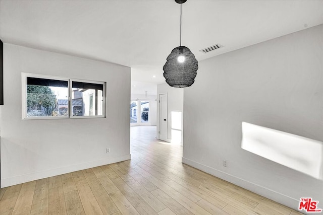 spare room with light hardwood / wood-style floors