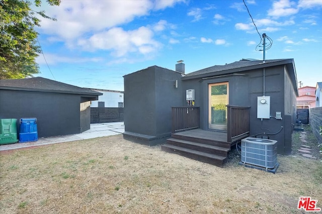 back of house featuring central AC