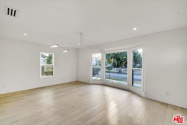 unfurnished room featuring light hardwood / wood-style floors