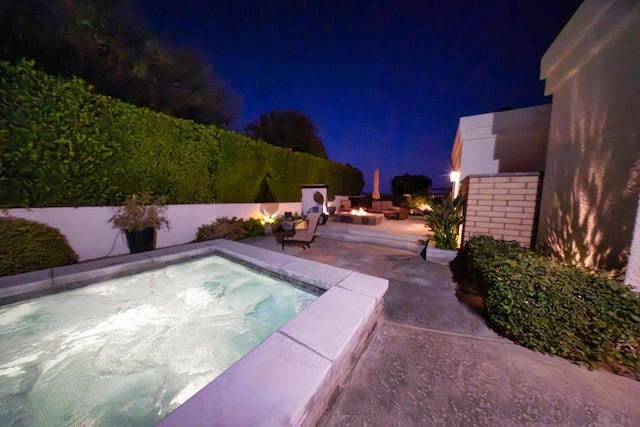 pool at twilight featuring a patio