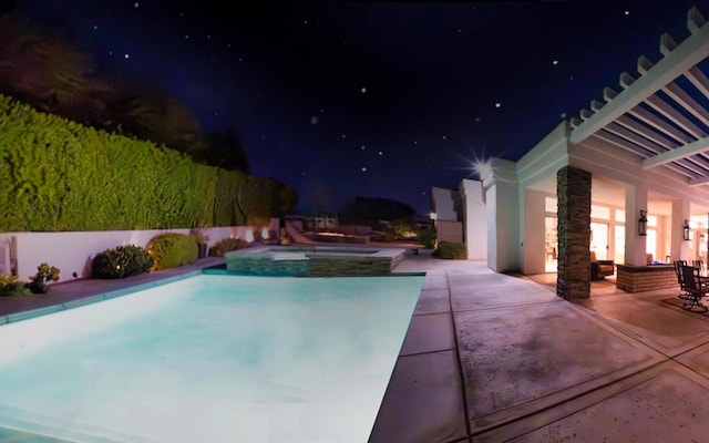 pool at night with a patio