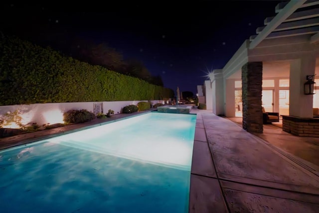 pool at night with a patio