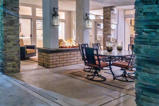 dining area with ornate columns and concrete flooring