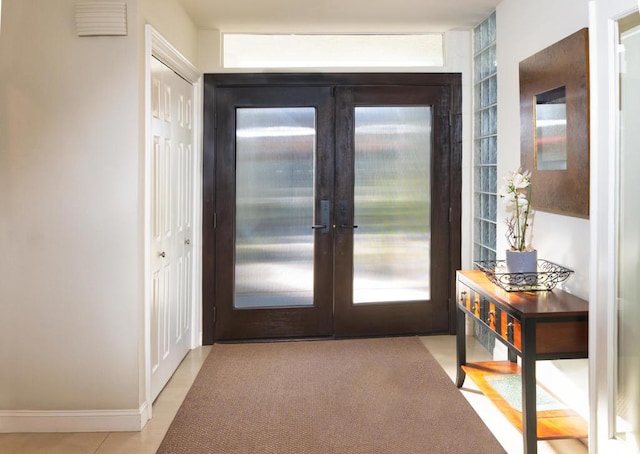 doorway with light tile patterned flooring and french doors