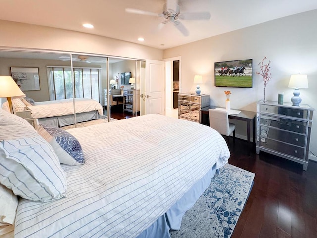 bedroom featuring a closet, dark hardwood / wood-style flooring, and ceiling fan