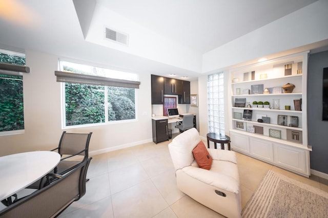 tiled office space featuring built in shelves