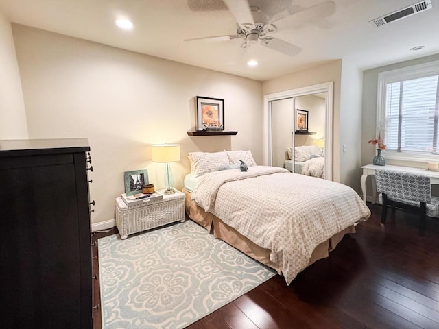 bedroom featuring ceiling fan, wood-type flooring, and a closet