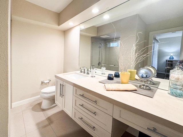 bathroom featuring toilet, a tile shower, tile patterned floors, and vanity