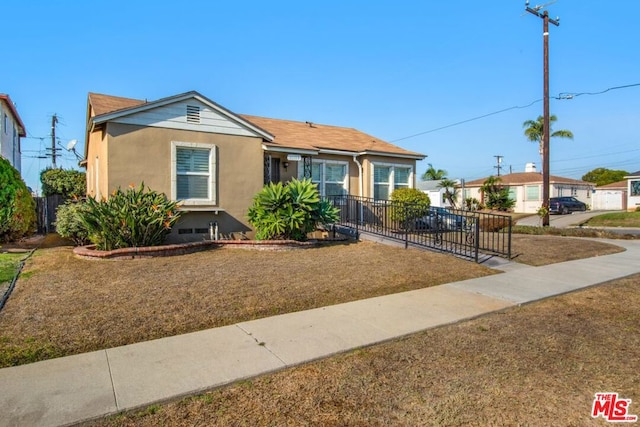 bungalow-style home with a front lawn