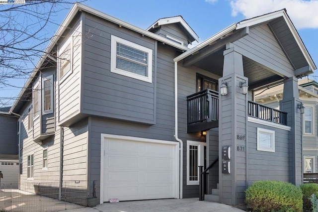 view of front facade featuring a balcony and a garage