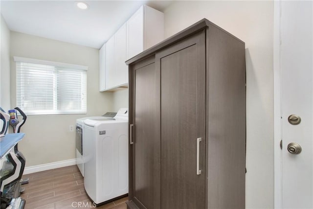 laundry room with washer and clothes dryer and cabinets