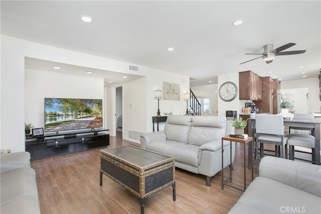 living room featuring wood-type flooring and ceiling fan