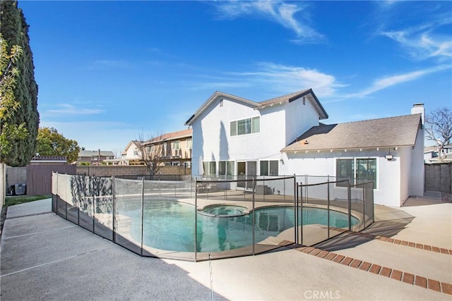 view of pool with an in ground hot tub and a patio