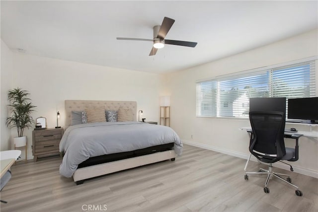 bedroom with ceiling fan and light hardwood / wood-style flooring