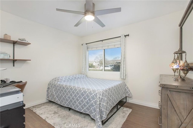 bedroom with ceiling fan and dark wood-type flooring